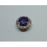 A tanzanite and diamond pendant, marked '9K', gross weight 0.95 grams.