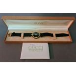 A vintage 1990s Gucci Stack 2000M gold plated watch with enameled back, with papers and box.