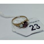 A hallmarked 9ct gold garnet and opal ring, size L/M, gross wt. 1.77g.