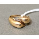 A 9 carat gold ring modeled as dolphins, size P/Q, gross wt. 4.9g.
