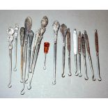 A collection of 10 Victorian button hooks, most with silver handles and six Victorian advertising