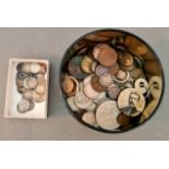 A tin of assorted Gb and world coins to include silver threepences etc.