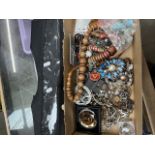 A box of costume jewellery and a hanging jewellery display.