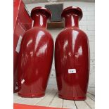 2 large burgundy vases.