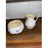 Belleek china - a milk jug and sugar bowl, both with green back stamps