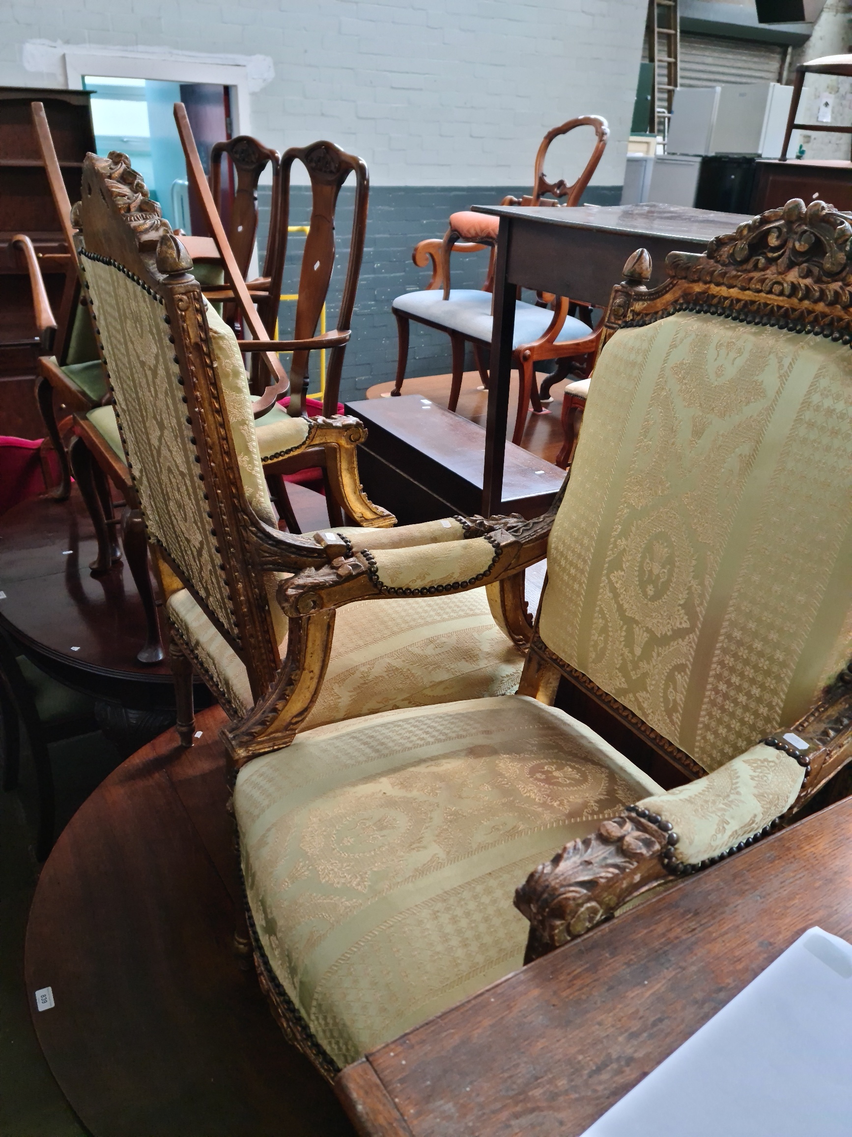 A pair of French gilt painted and carved wood armchairs, circa 1900, width 65cm, depth 65cm & height