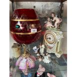 A large red glass, an onyx table lighter, a Capodimonte mantle clock and floral ornament, and a