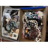 Two boxes of assorted costume jewellery.