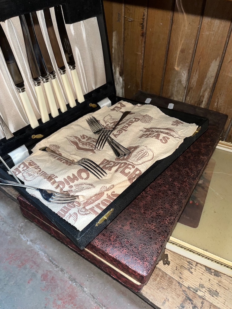 Two sets of plated cutlery and a breakfast tray