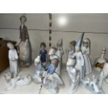 11 Lladro figures, various sizes. One has a damaged hand. Also 2 Nao figures