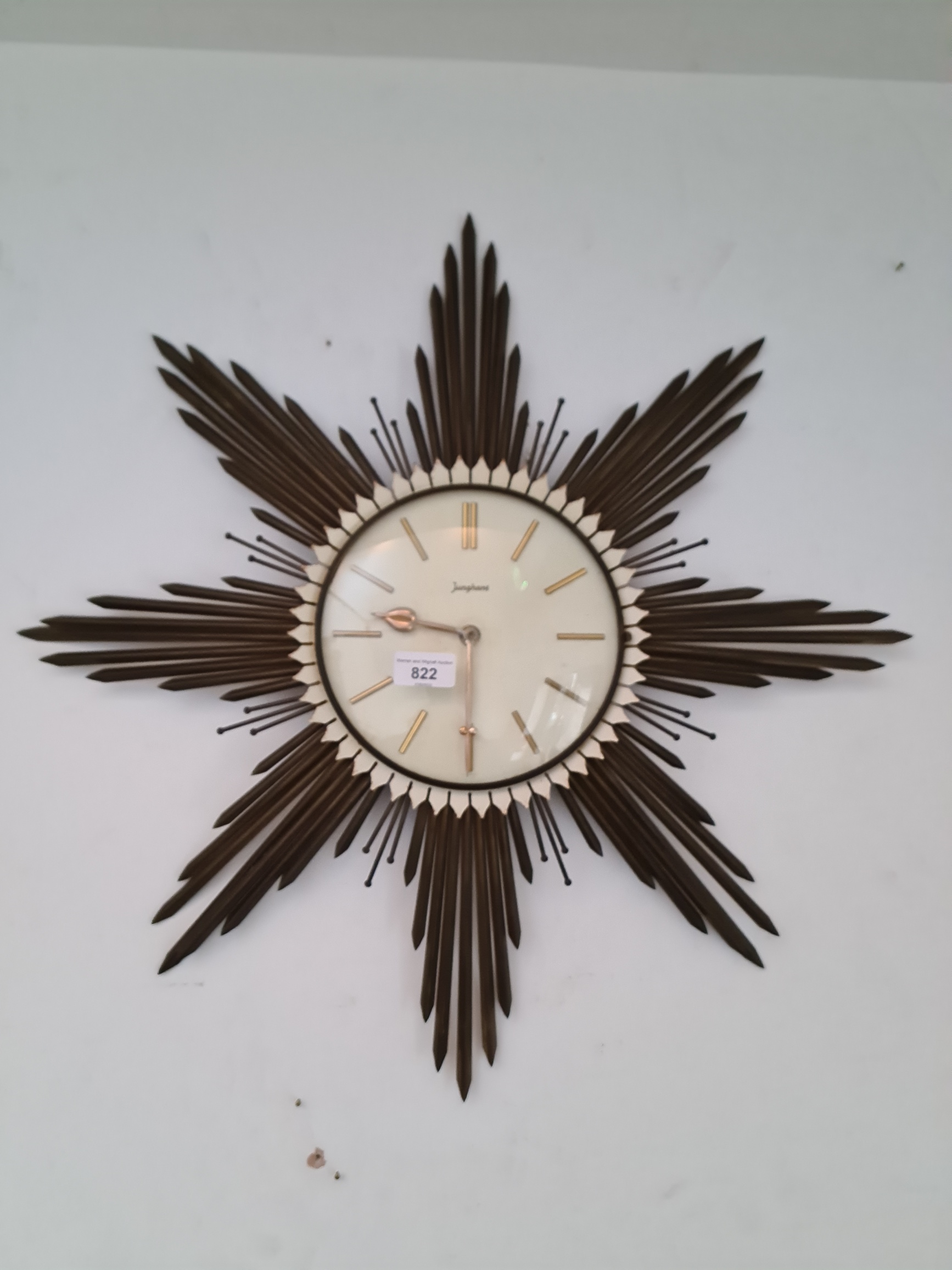 A mid 20th century metal framed sunburst wall clock by Junghans, diameter 60cm.