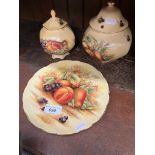 Three pieces of Aynsley 'Autumn Gold' pottery including lidded pots and a plate.