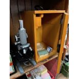 A vintage microscope model L-201 in wooden box together with extra lenses.
