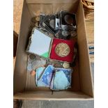 A box of world coins and notes including commemorative crowns, and a cased Chinese Tourism coin