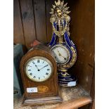 An early 20th century oak cased mantle clock together with a ceramic and gilt decorated mantle