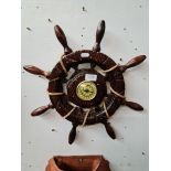 A barometer modelled as a ship's wheel.