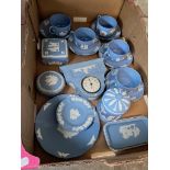 A box of assorted Wedgwood blue Jasper ware including cups and saucers and a clock etc.