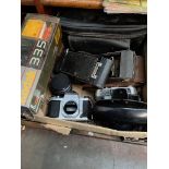 A box of cameras and accessories to include folding Kodak No2 Autographic Brownie, Pentax, Halina