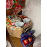 A Chinese tea set in fitted straw basket, together with a pair of stress balls