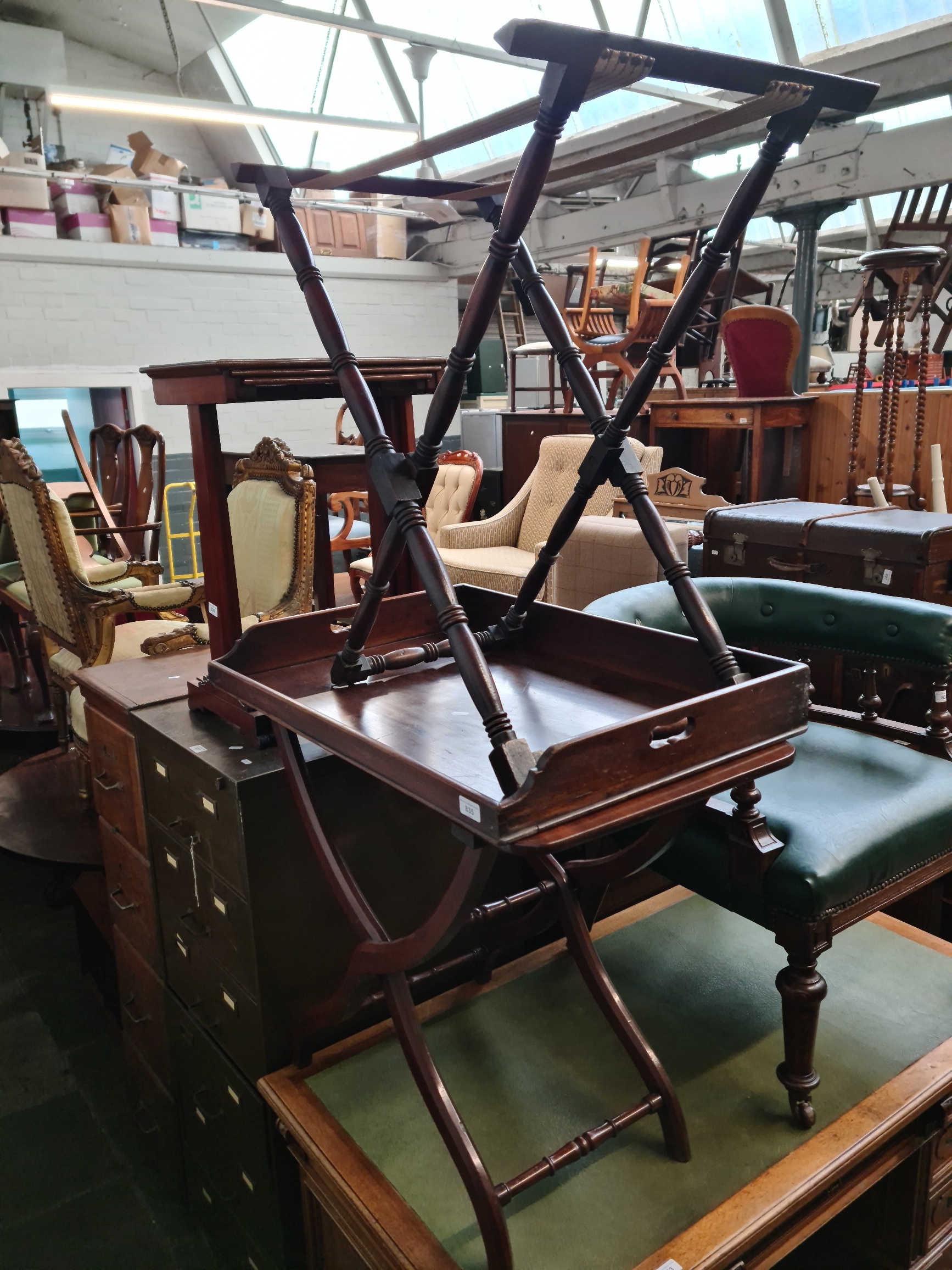 A Georgian mahogany butler's tray with folding stand and an Edwardian folding table.