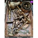A box of assorted brassware to include candlesticks, bowls, horse brasses, etc.