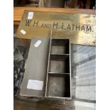 A brass plaque 'W.H. and H. Latham' and a silver plated casket.