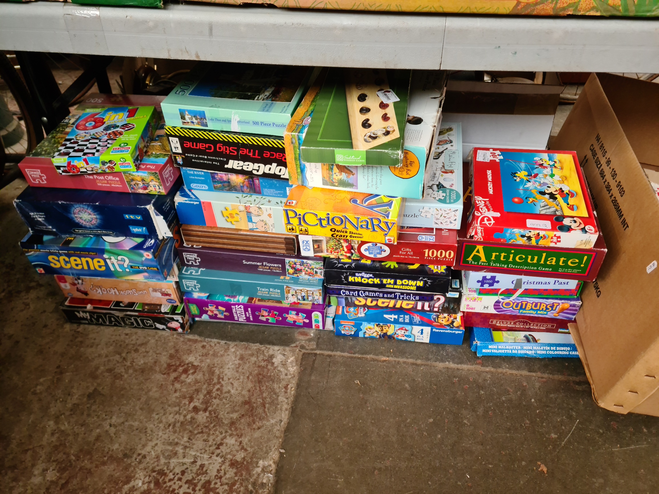 A large collection of boxed games and jigsaws, including Articulate, Magic set, Top Gear game etc