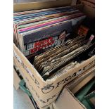 A box of mainly 1960s to 1980s popular music on vinyl and cassette, folk, country along with comic