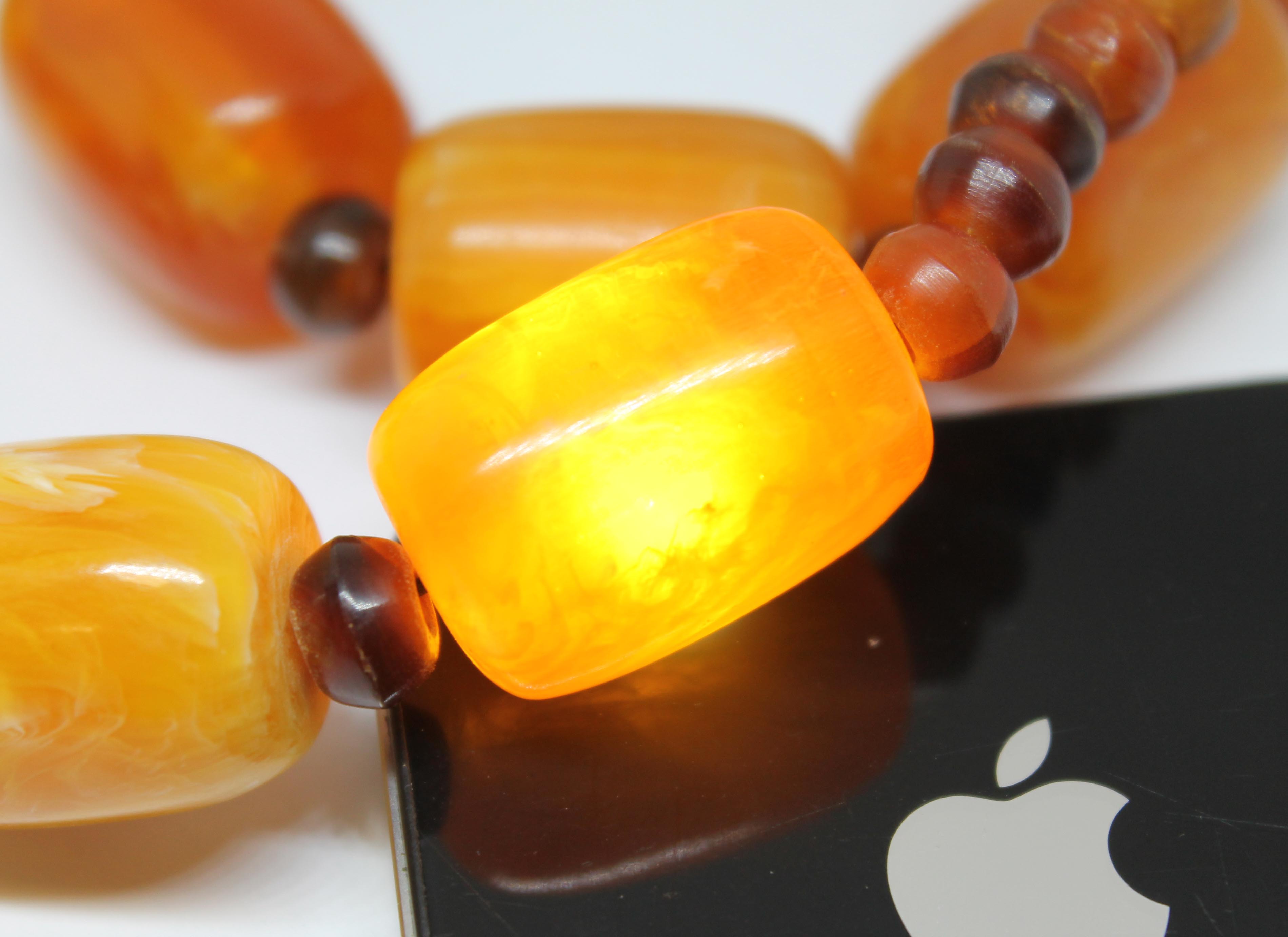 A butterscotch plastic bead necklace, length 54cm, gross wt. 114g. - Image 5 of 8