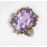 A 9ct gold ring featuring a rectangular rose cut amethyst, floral setting set with diamonds,