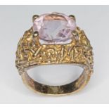 A 9ct gold Brutalist style amethyst ring, the round mixed cut stone weighing approx. 5.52ct,