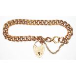 An early 20th century engraved link bracelet with heart shaped padlock clasp, marked '9c', length