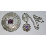 Two pieces of Celtic style Scottish jewellery comprising an amethyst set target brooch marked '