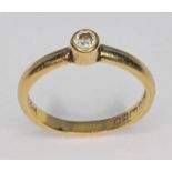 A hallmarked 18ct gold bezel set diamond ring, gross wt. 1.9g, size G.