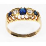An antique hallmarked 18ct gold ring set with two diamonds, two sapphires and central blue paste,