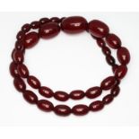 A graduated marbled cherry bakelite bead necklace, the beads ranging in length from approx. 10mm