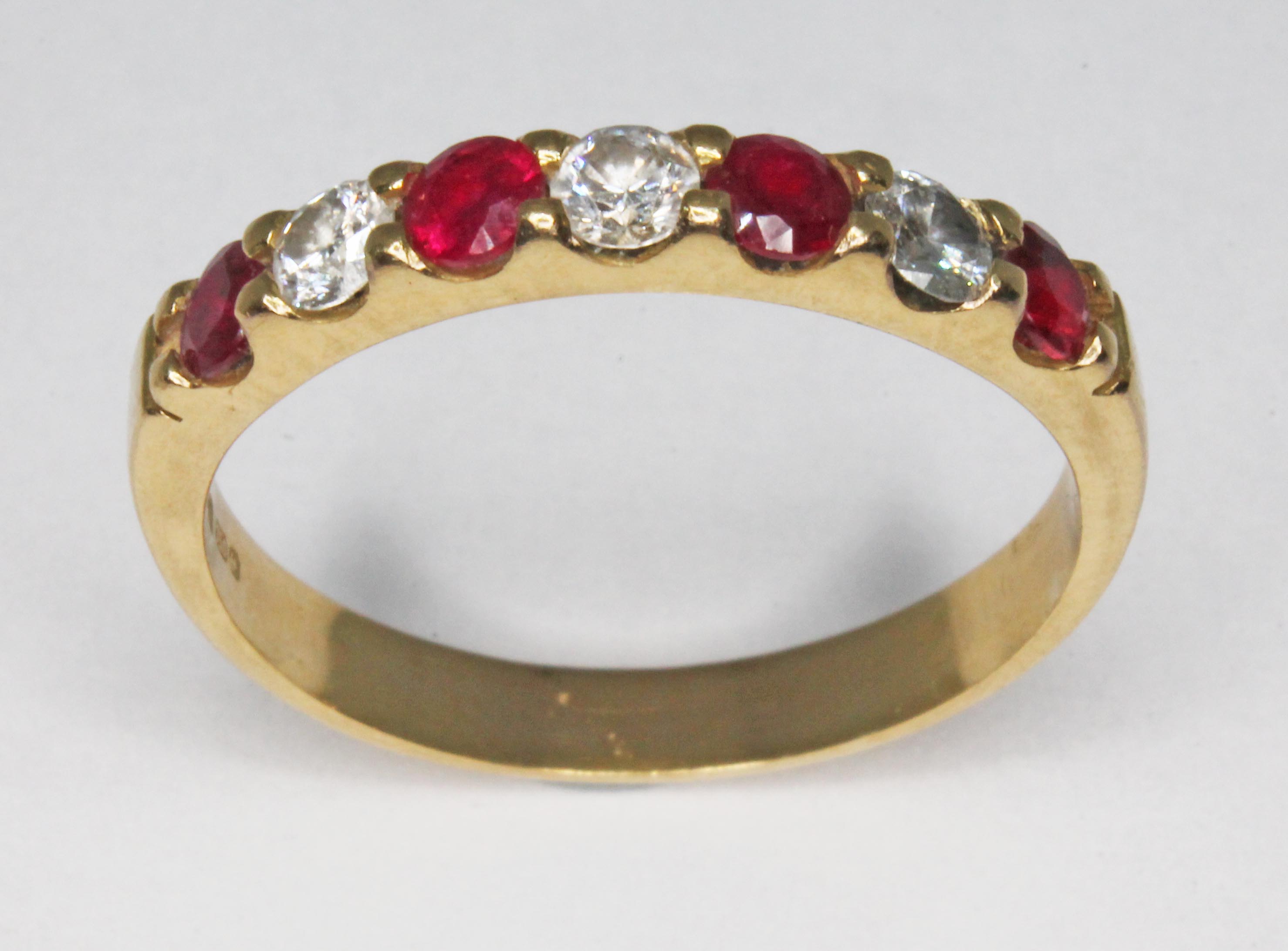 A seven stone diamond and ruby ring, total approx. diamond wt. 0.30ct, hallmarked 18ct gold, sponsor