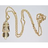 A tribal style pendant, marked '18K', length 32mm, on 48cm chain marked '750', wt. 6.9g.