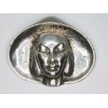 A mid 20th century Modernist cast brooch depicting a lady wearing a hat, marked 'Silver', length