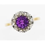 An amethyst and diamond cluster ring, the round cluster measuring approx. 10.50mm in diameter,