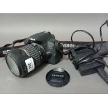 A Cannon EOS 700D with battery charger.