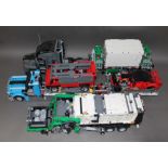 A group of three Lego Technic models comprising two Mack Anthem Truck and Auto Transporter