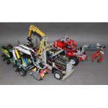 A group of three Lego Technic vehicles comprising Logging Truck, Forest Machine and articulated