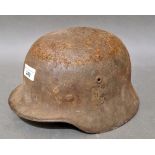 A WW2 German M42 military steel helmet with some remnants of original paint on surface.