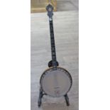 A John Grey & Sons four string banjo, inlaid with mother of pearl to neck, associated soft case.