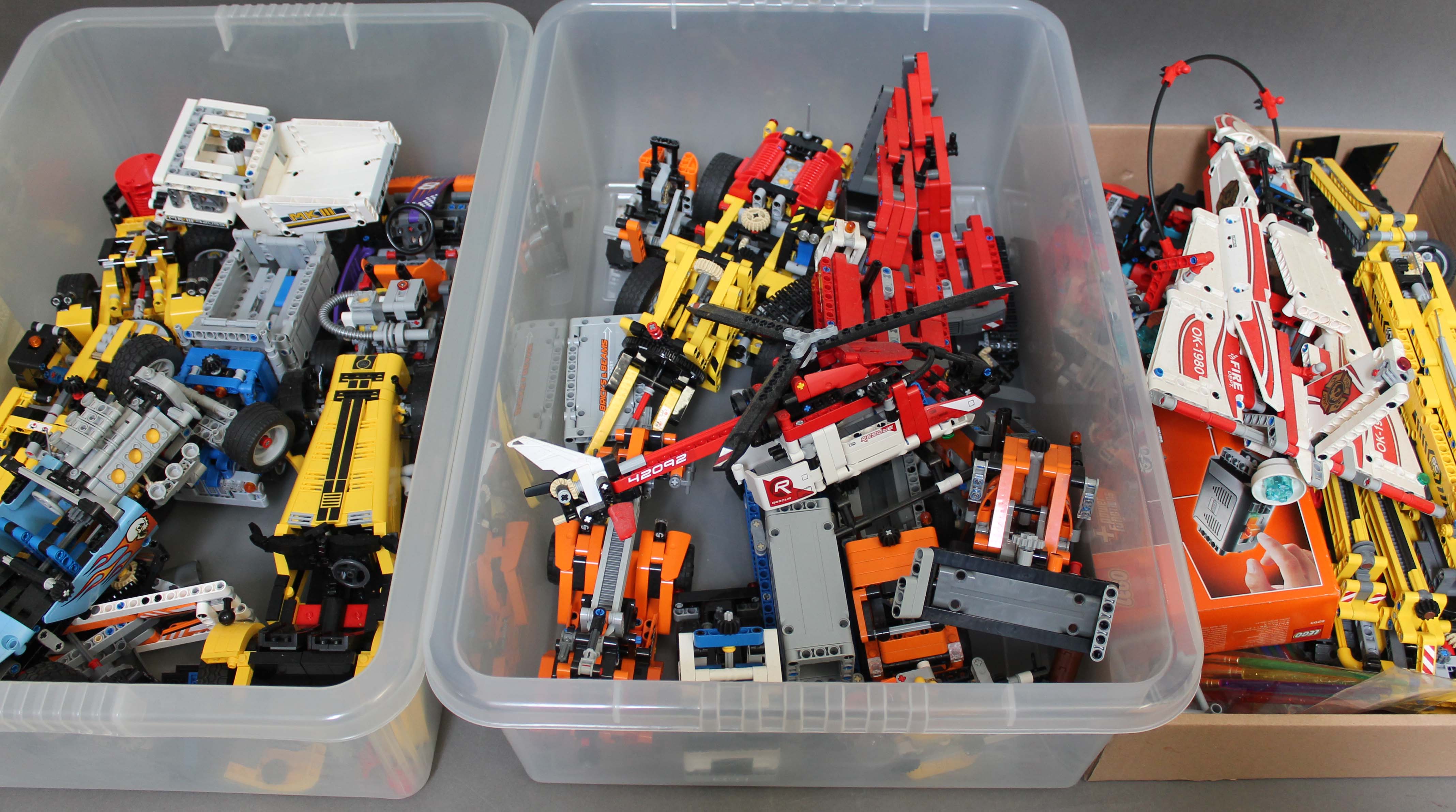 Three boxes of assorted Lego Technic models.