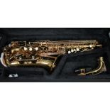 A Muslady brass alto saxophone with hard case.