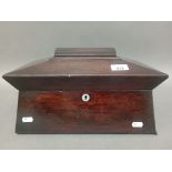 A 19th century rosewood sarcophagus tea caddy with mother of pearl escutcheon and ring handles.
