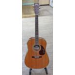 A 'Vintage' electro acoustic guitar with soft case.