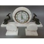 A 1930s Art Deco white marble mantle clock with garniture.